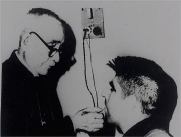 Stratton receiving communion in North Vietnamese POW prison